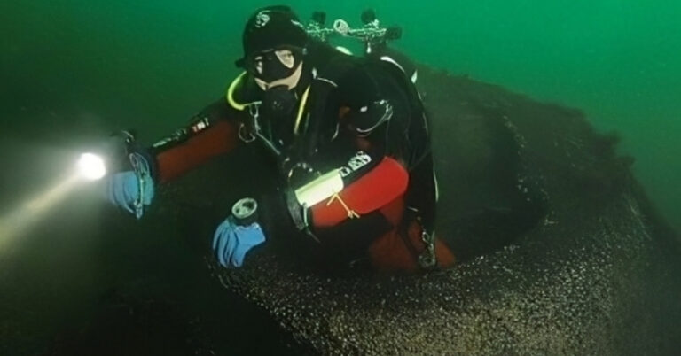 Diver Roman emerges from an opening on the Schleswig Holstein