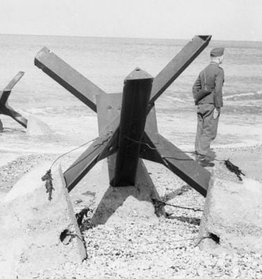 Czech Hedgehog anti-tank obstacles and German soldier