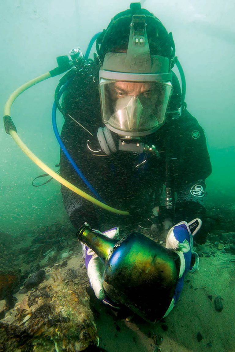 Diver with a blue-green bottle found intact on the Invincible.