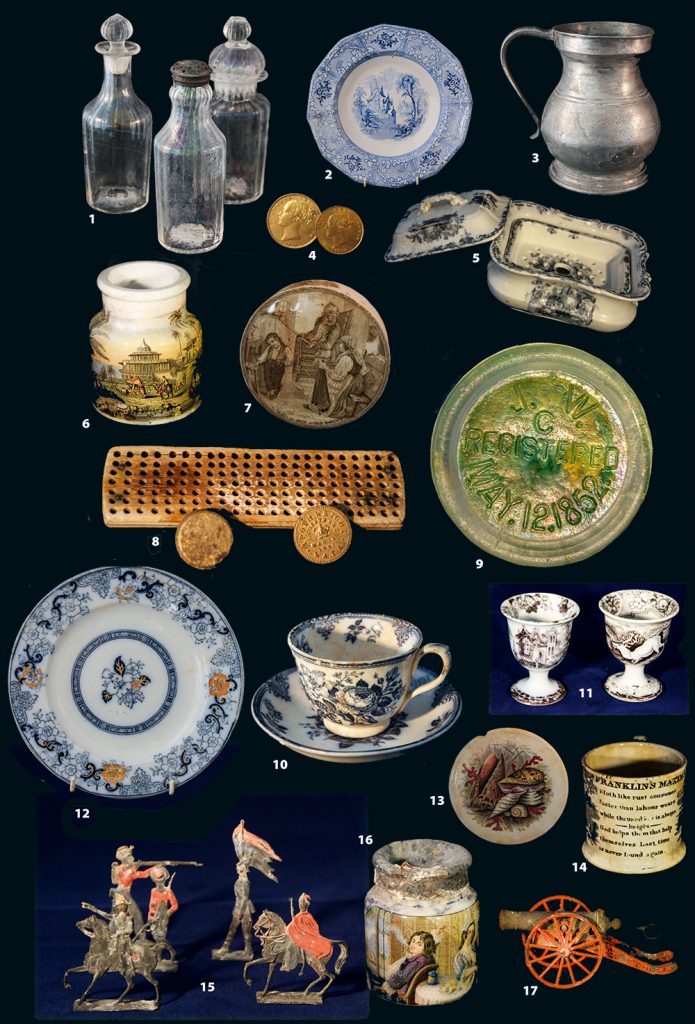 Artefacts from the Josephine Willis: 1 Crystal bottles; 2 oriental decorated plate; 3 pewter jug bearing the maker’s stamp; 4 gold coins; 5 soap dish; 6 hand-painted ink-well; 7 toothpaste pot lid; 8 remains of a hairbrush and some uniform buttons; 9 The glass lid that led to identification of the wreck; 10 rose and lily- patterned cup and saucer;  11 decorated egg-cups; 12 gold-leaf plate; 13 lid of a toothpaste pot; 14 mug decorated with drawings and poems; 15 toy soldiers; 16 hand painted ink well; 17 toy cannon.