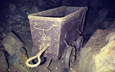 An old mine-cart, still on the rails as it was left.