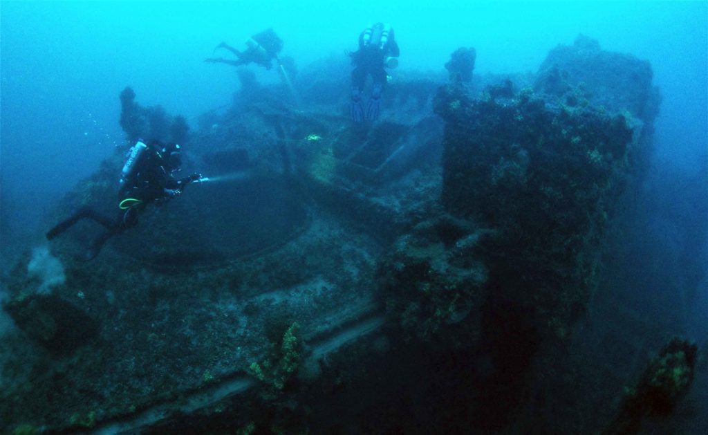 Wide view of Chartage wreck with Scuba DIvers