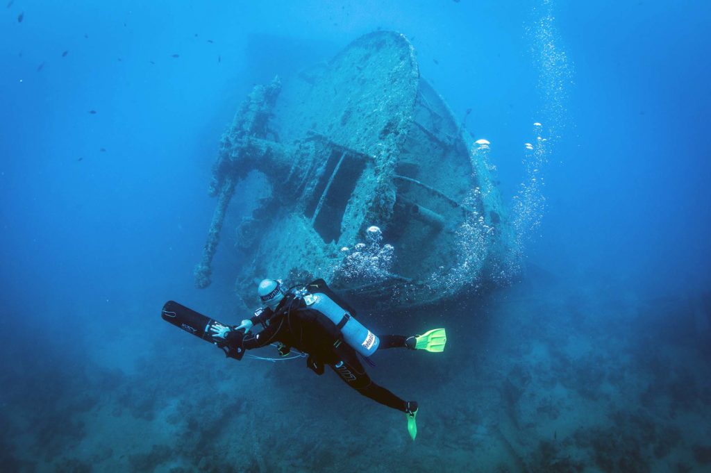 diver with DPV on wreck