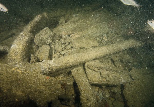 Admiralty-pattern anchors stored on deck by the winch