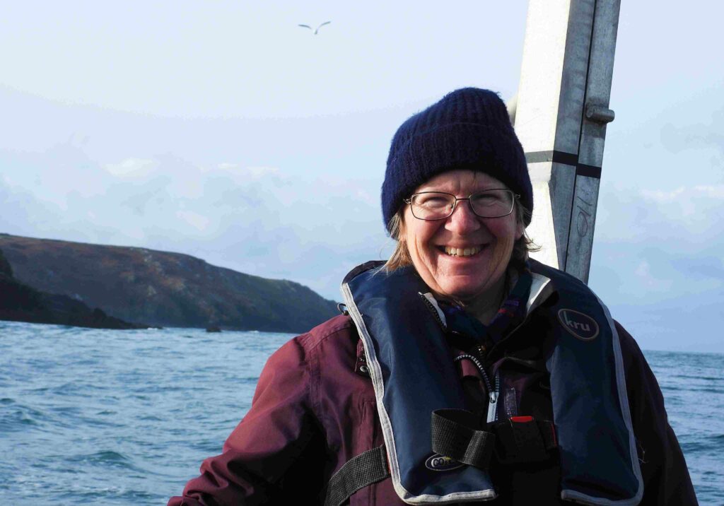 Kate Williams recording marine life out at sea (Sue Sayer / Seal Research Trust)