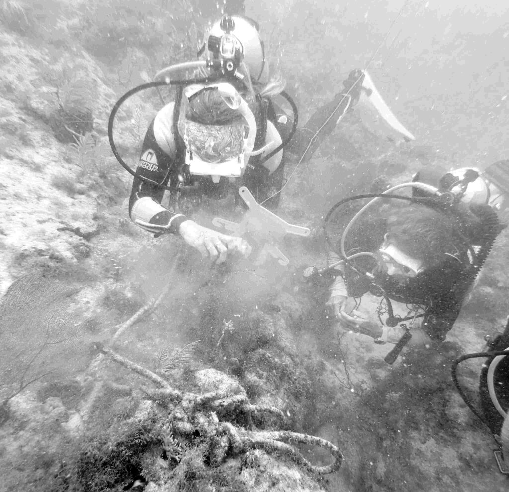 Divers working to remove the damaging anchor, chain and line