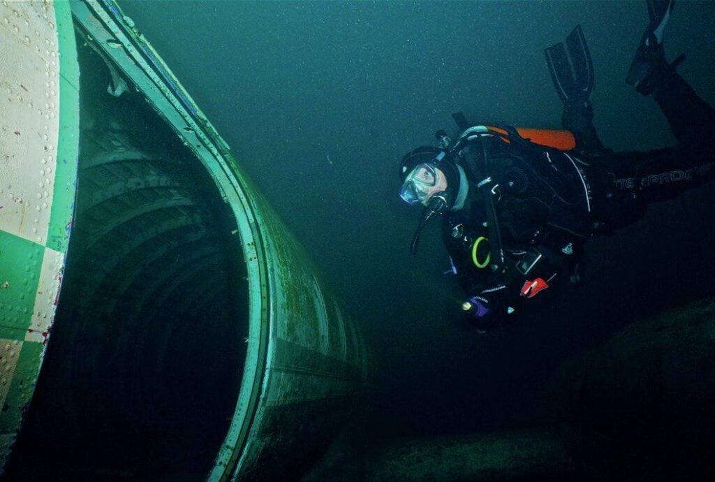 The Importance of an Emergency Action Plan for Divers 1 scuba diver swimming near wrecked plane 1
