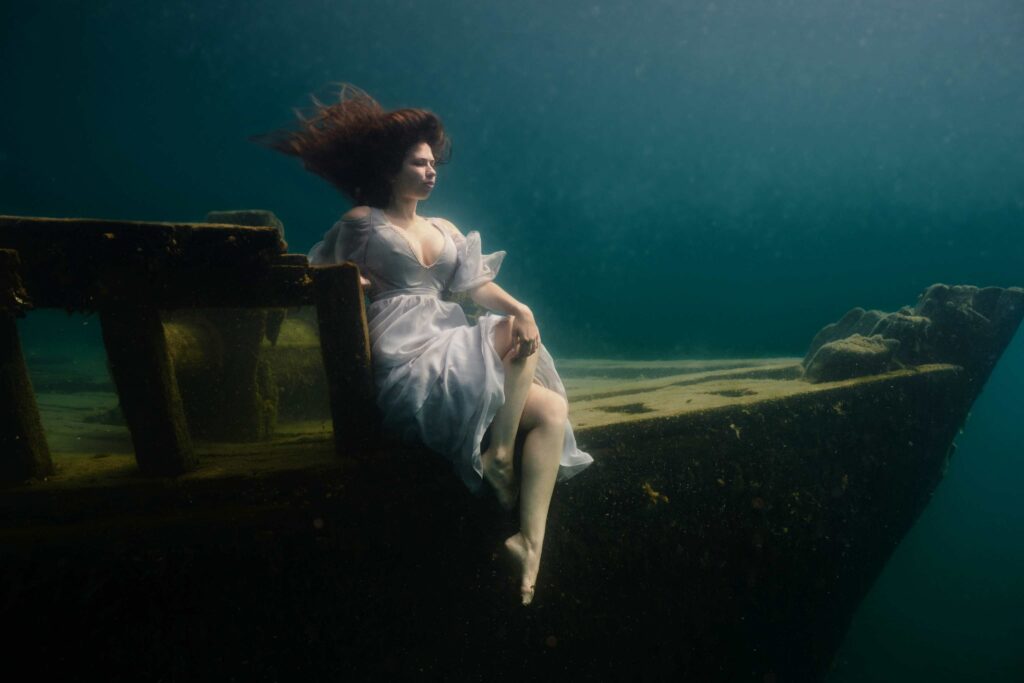 Model Ciara Antoski on the first world record shoot. Permission is required to have models sitting on the wrecks (Steve Haining)
