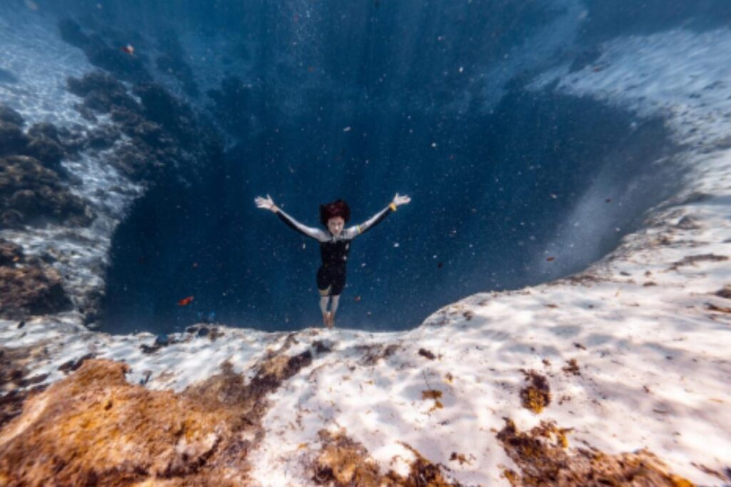 Sadurska in the Blue Hole (Vertical Blue)