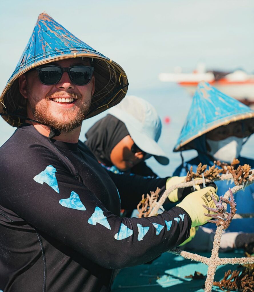 Callum Hobbs works to prepare the coral cuttings for planting (MSS)