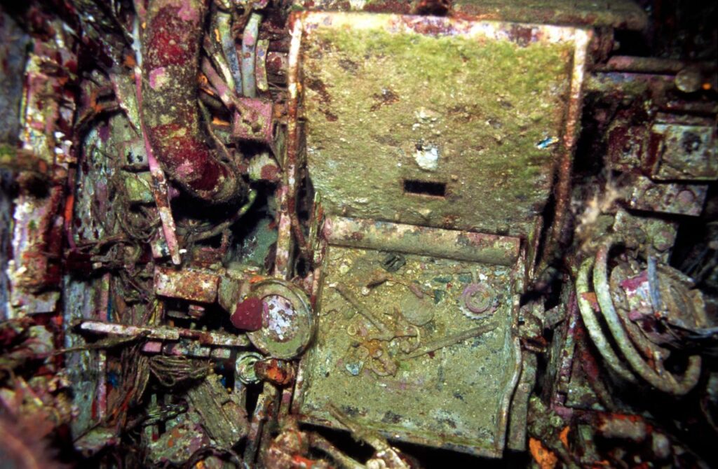 The pilot’s armoured seat. The faceplate on the right seems to be from the compass – on the other side are the port and starboard fuel-cock hand-wheels