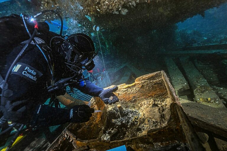 Parks Canada underwater archaeologist Marc-André Bernier carefully excavate a seamen’s chest in the forecastle on the lower deck (Brett Seymour / Parks Canada)