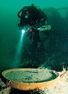 Stevie Adams shines light on a porthole.