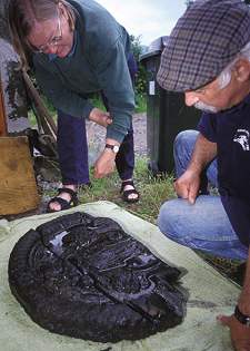 Colin and Paula Martin examine a recent carving recovered from the Swan