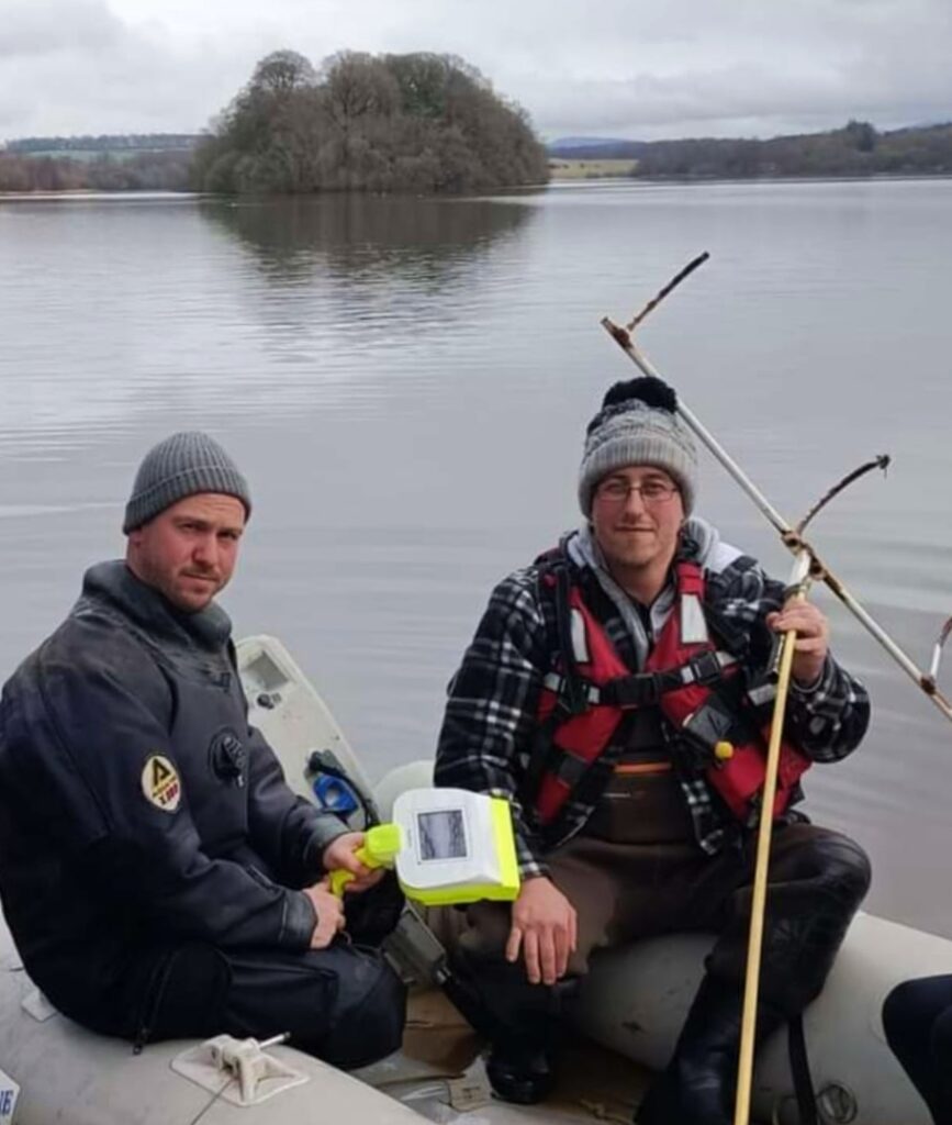 Phil Jones and Thomas Stoddart - holding the homemade rake he was using to dredge for his cousin’s body in January