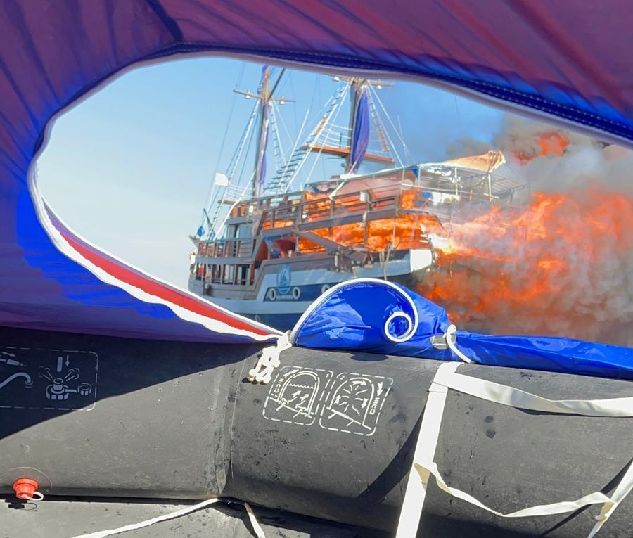 View of the blazing Sea Safari VII from a life-raft (Mike Day)