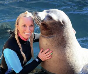 Sarah and a marine mammal friend|Sarah hunting lionfish in the Caribbean||||||||