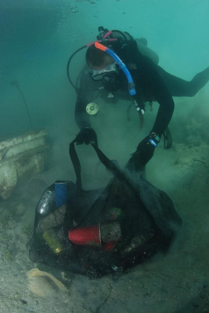 Divers bring collect bags of trash image credit Blue Lagoon
