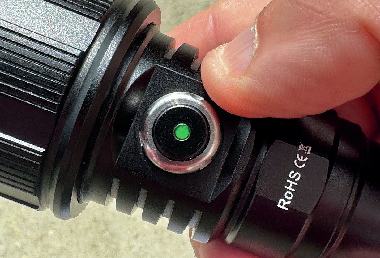 OrcaTorch ZD710 MK2 Dive Torch Review: Adjustable Beam and 1500-Lumen USB-C Rechargeable Light 2 Detail of OrcaTorch ZD710 MK2 control button showing power indicator and lock function.