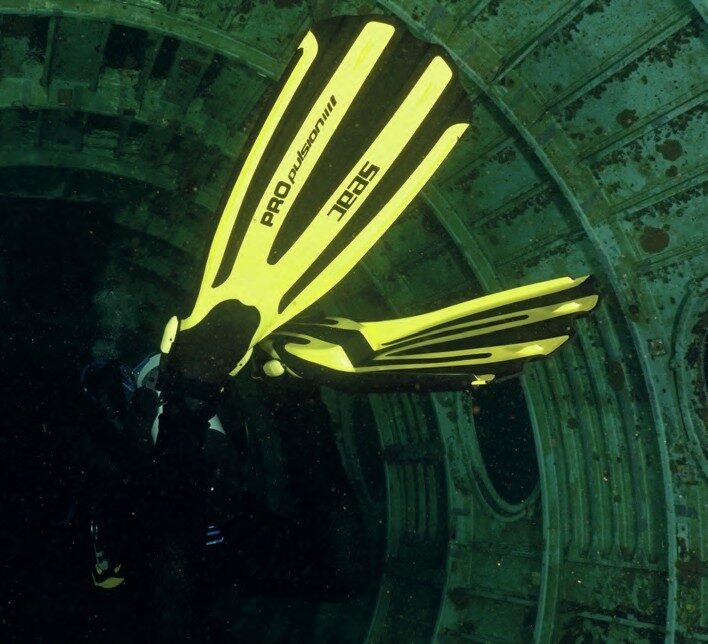 Diver using SEAC Sub Propulsion S fins underwater inside shipwreck showing power and manoeuvrability.