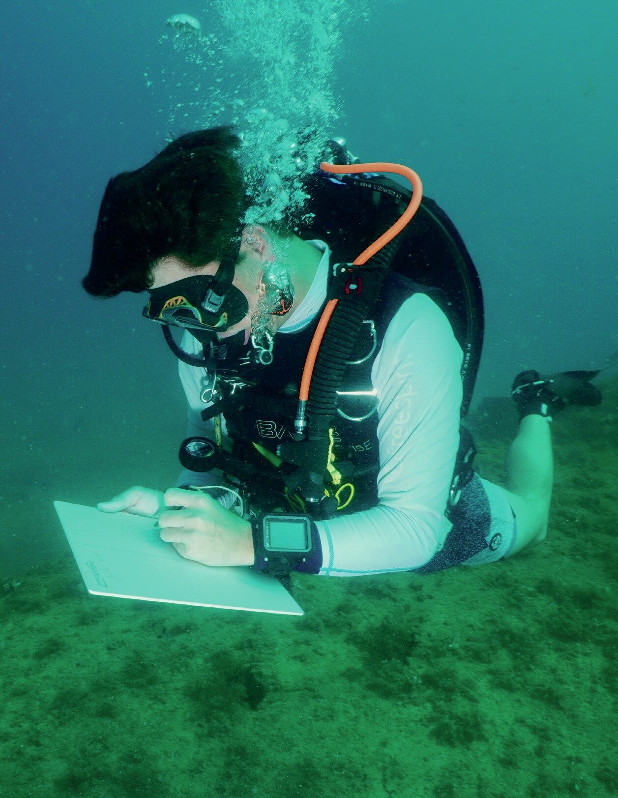 PADI Wreck Diver student mapping HMS Maori wreck with slate in Malta scuba diving course