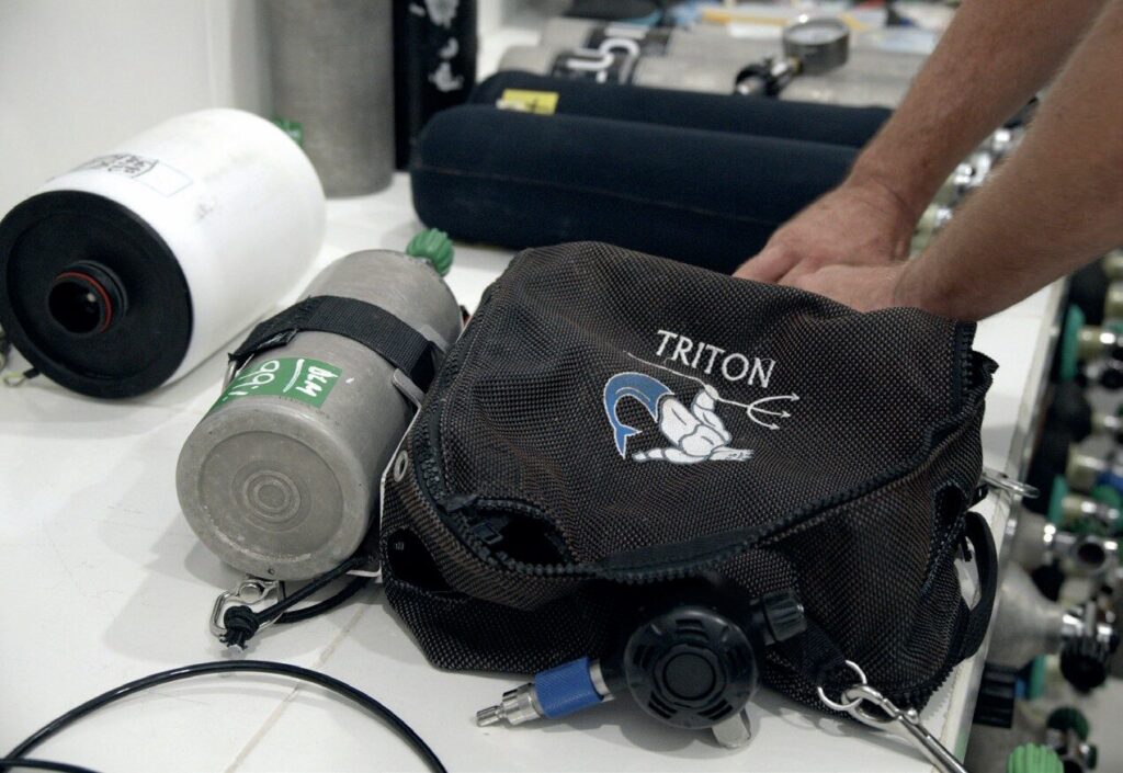 Entering the World of Closed Circuit: My Journey into CCR Diving and Rebreathers 4 Diver assembling a compact CCR unit before dive