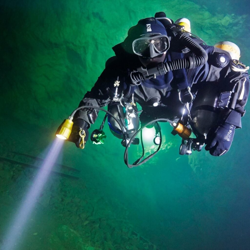Diver in full technical diving gear ready to film