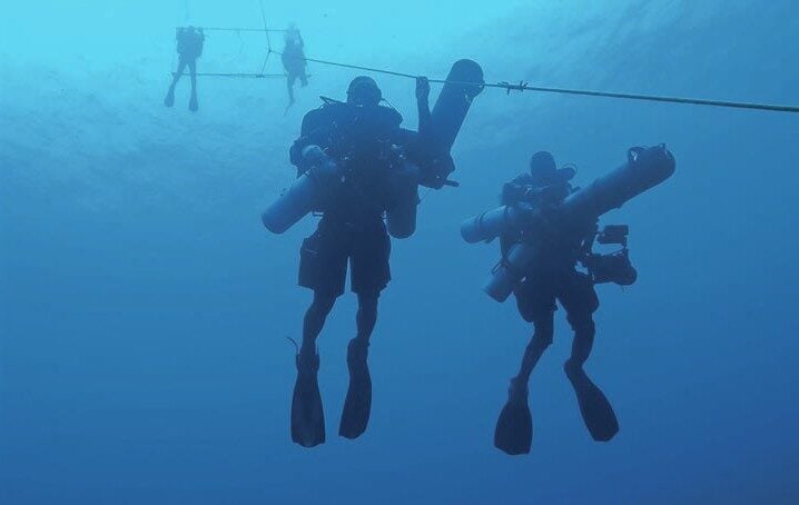 Divers completing long decompression after deep wreck exploration