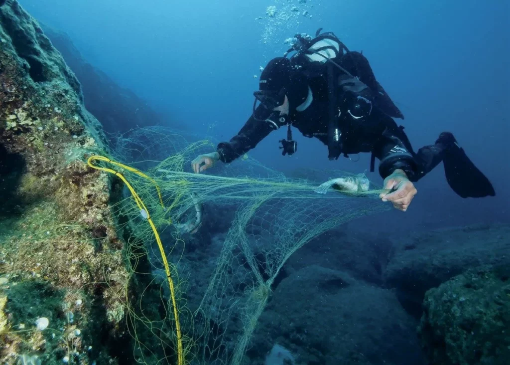 Diver removing an abandoned net on the way back to the boat