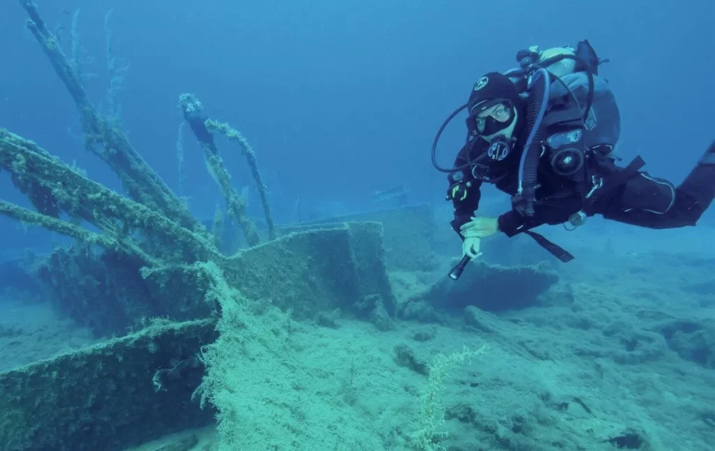 Diver exploring the wreck of SS Minnewaska III in Souda Bay, Crete