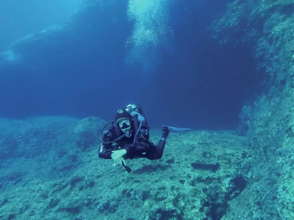 a diver at the entrance to Elephant Cave in Crete