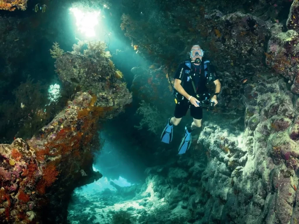 Sunlight filtering through caverns at St John’s Caves in the Red Sea