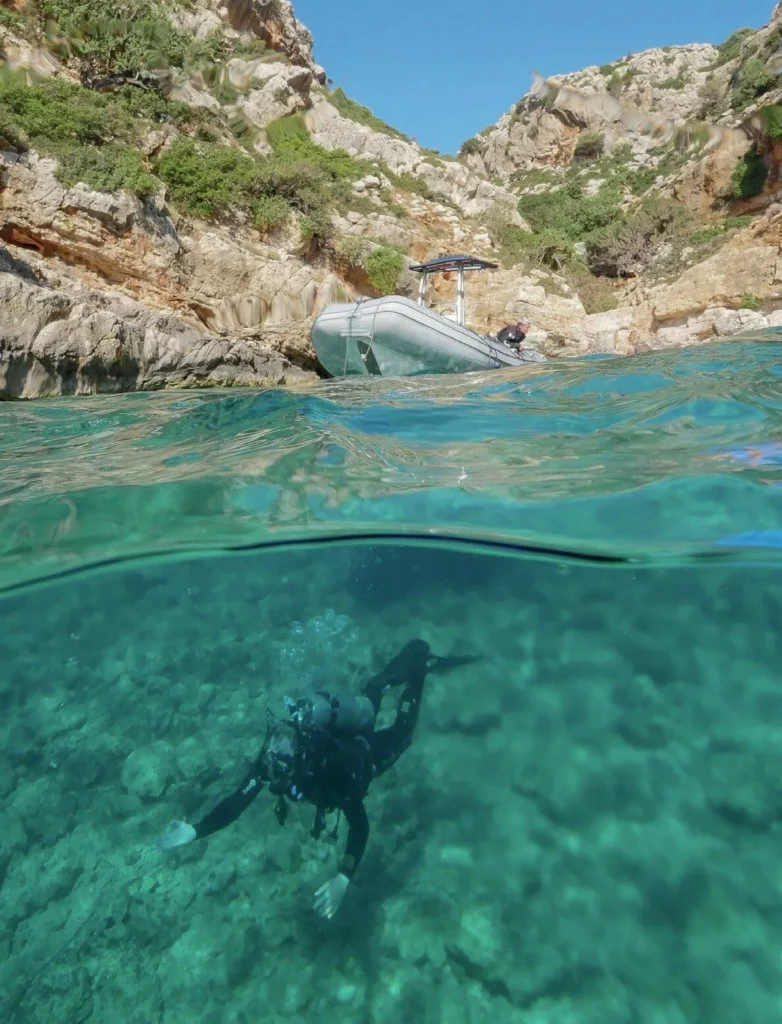 Scuba diver exploring clear Mediterranean waters off the coast of Crete