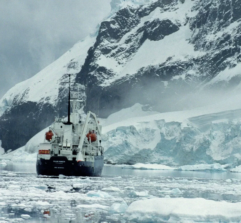 Iceberg Diving in Greenland: Beauty, Danger and Essential Safety Protocols 12 A boat floating among ice on the coast of Greenland