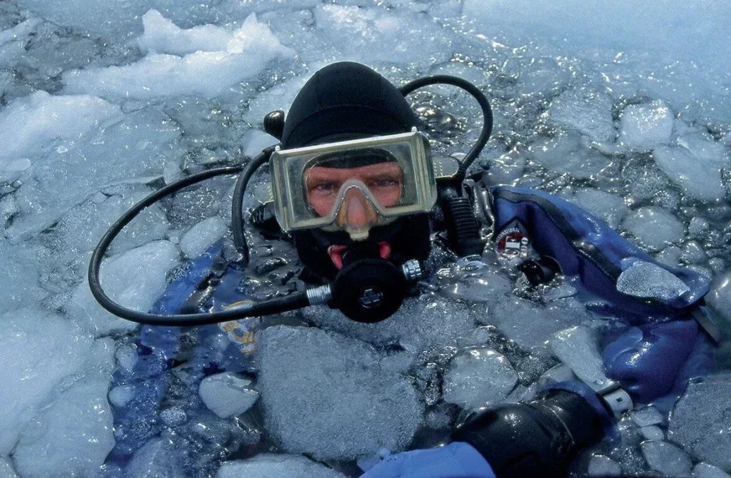 Iceberg Diving in Greenland: Beauty, Danger and Essential Safety Protocols 8 A diver preparing to descend onto an iceberg in Greenland in a drysuit