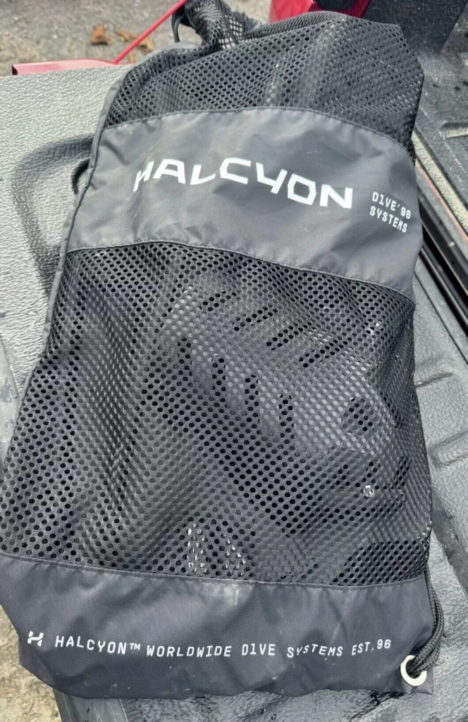 A pair of black Halcyon Vector Pro technical diving fins packed into the provided net bag