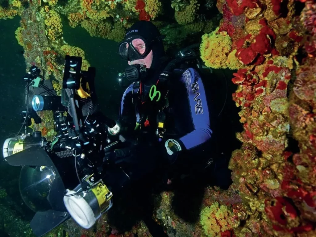 An underwater photographer exits the interior of the USS  Oriskany wreck in Florida