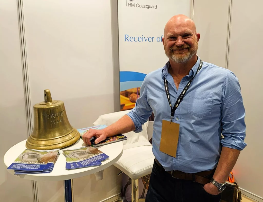 Receiver of Wreck Stephen White with the bell from HMS Druid at the Go Diving Show (Steve Weinman)