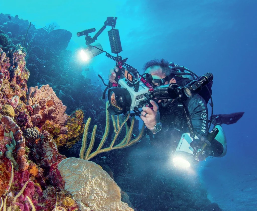Diving Saba and St Kitts: Pinnacles, Wrecks, and Volcanic Wonders 2 An Underwater photographer lining up a shot on the reefs of Saba