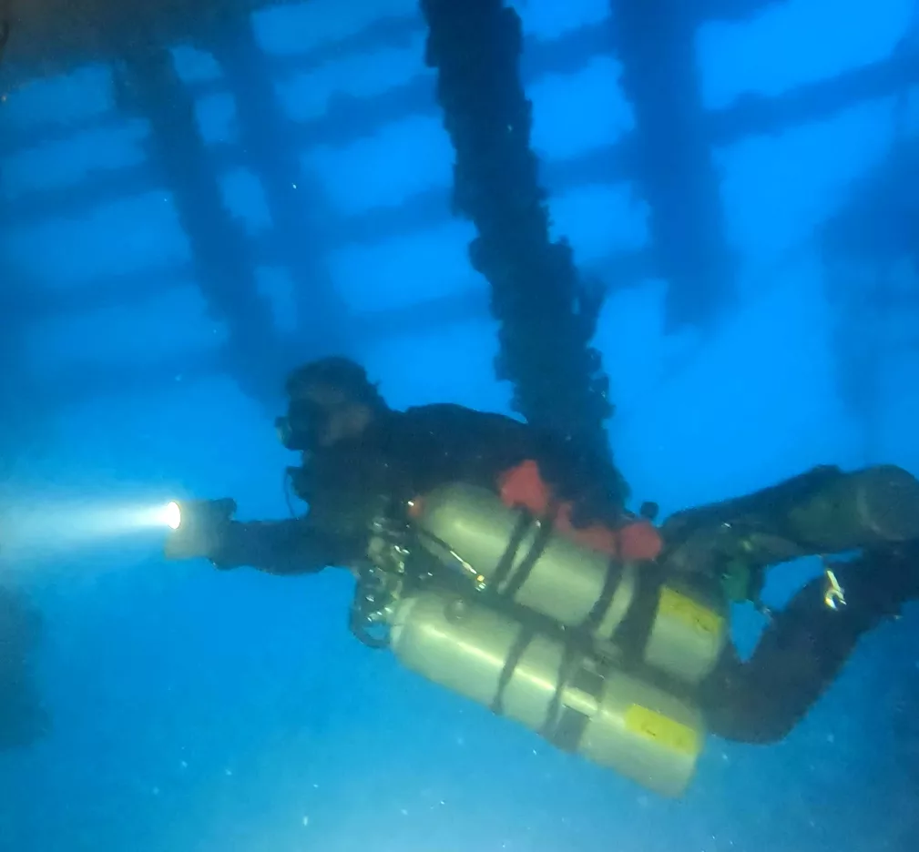 Beneath the inverted deck of the Seacrest near the dive station