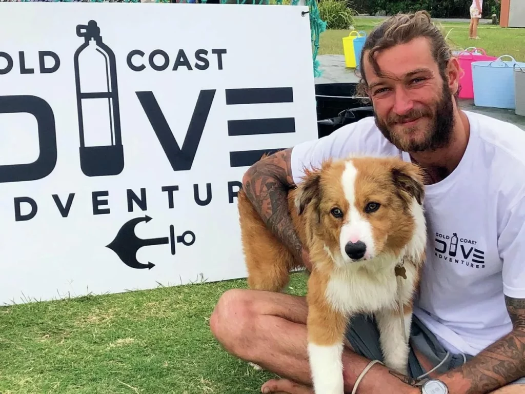 Diving with Harry Cottrell: The Rise of Gold Coast Dive Adventures 6 Harry Cottrell relaxing with his dog at the GCDA shop, highlighting the inclusive community atmosphere of the dive club.