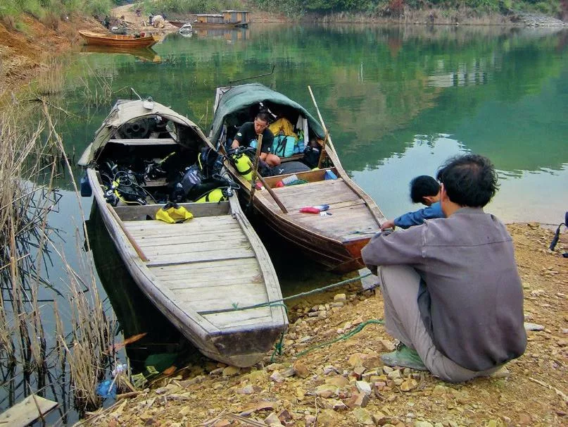 Local Chinese fishing vessels repurposed as dive boats for an expedition on Thousand Island Lake.