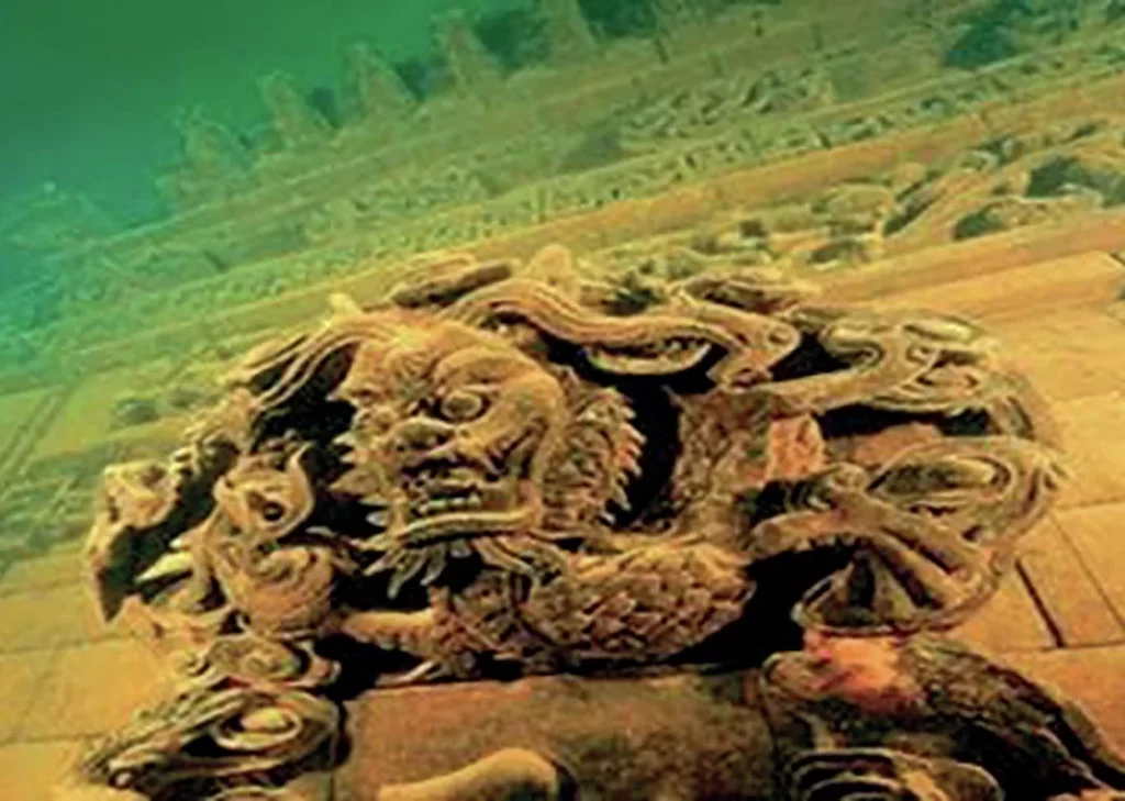 Close-up of intricate ancient stone carvings on a submerged building in the underwater Lion City of Qian Dao Lake.