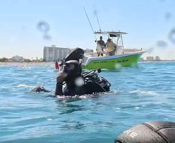 Stephanie Holter surfaces near the motor-boat (Abyss Explorers)
