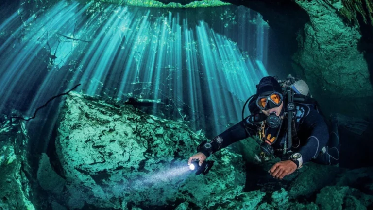 Stunning underwater sunbeams split into distinct rays by objects above the surface.