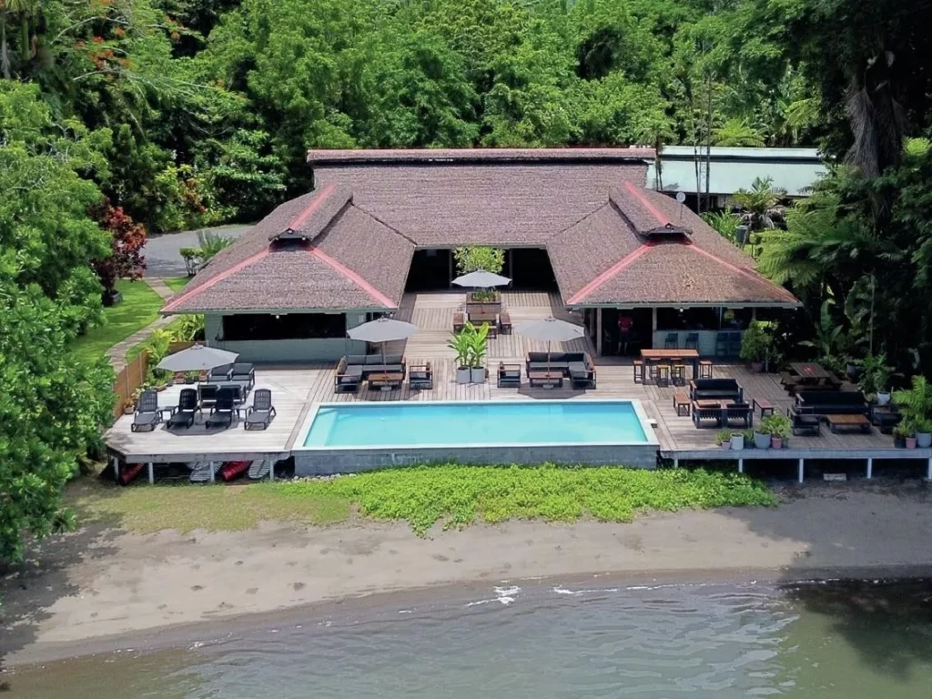 The wonders of Walindi: A Guide to Kimbe Bay, Papua New Guinea 2 A traditional-style guest bungalow at Walindi Plantation Resort surrounded by manicured tropical gardens.