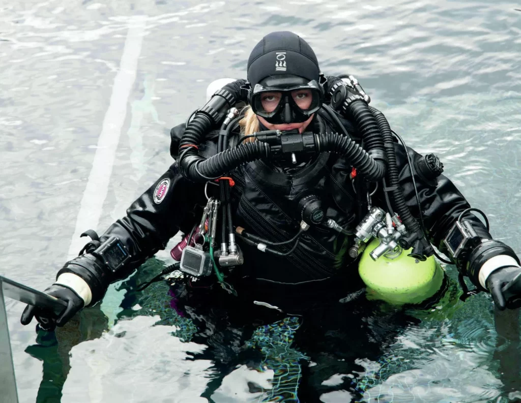 Iceland’s Underwater Frontier: Science in Silfra 2 Technical diver Yana Stashkevich in full rebreather gear at the surface before a scientific dive in Iceland.