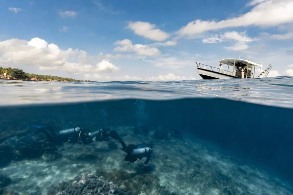 75% of scuba divers rate themselves 'above average' 3 Scuba divers starting a dive in Nusa Penida