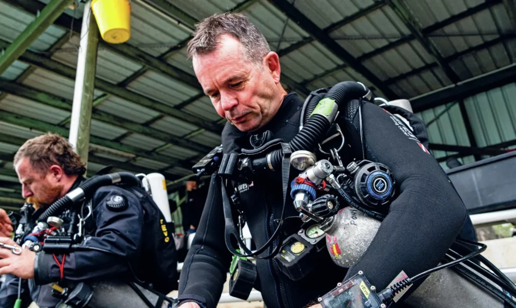 A diver preparing to jump into a pool in a rebreather try out dive