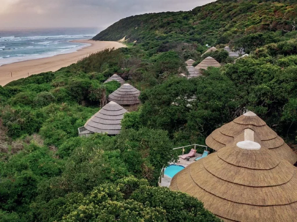 Discovering Sodwana Bay 14 An aerial view of a Sodwana Bay beach resort nestled in green foliage, providing accommodation for those visiting South Africa.